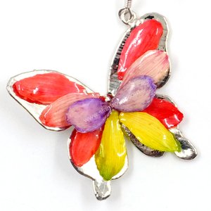 Silver plated Bird's Nest Fern cut into butterfly shape as base is layered with delicate flower Petals in assorted colors in 3D style; preserved in flexible, clear coating. Flower Petal colors can be changed.