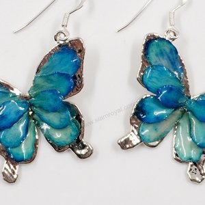 Silver plated Bird's Nest Fern cut into butterfly shape as base is layered with delicate flower Petals in assorted colors in 3D style; preserved in flexible, clear coating. Flower Petal colors can be changed.