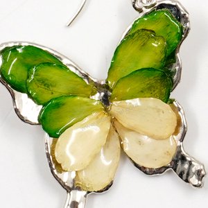 Silver plated Bird's Nest Fern cut into butterfly shape as base is layered with delicate flower Petals in assorted colors in 3D style; preserved in flexible, clear coating. Flower Petal colors can be changed.